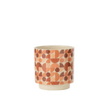Pot de fleurs Trivial J-Line sur une table, ajoutant une touche de couleur