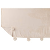 Vue de face du plaid Pompom J-Line beige sur un fauteuil