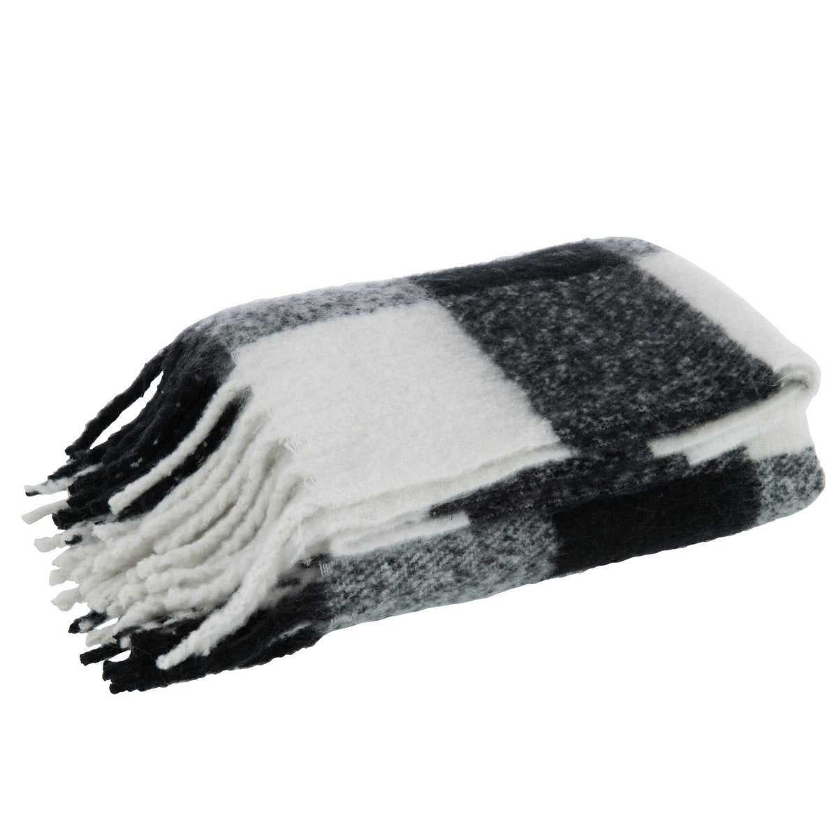 Plaid J-Line drapé sur un canapé moderne, ambiance cosy