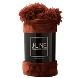 Plaid Pompom rouge marsala en situation dans un salon