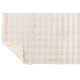 Plaid J-Line Wave drapé sur un canapé moderne