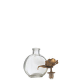 Bouteille J-Line Flower sur une table, ajoutant une touche de luxe à la décoration
