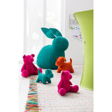 Figurine J-Line en velours rose sur une table en bois