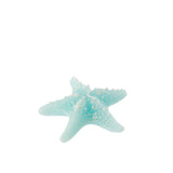 Bougie Étoile de Mer J-Line en cire azur, mise en scène dans un salon