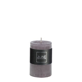 Bougie cylindrique J-Line Granite gris posée sur une table moderne