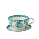 Ensemble de la tasse et soucoupe J-Line Grenade sur une table en bois