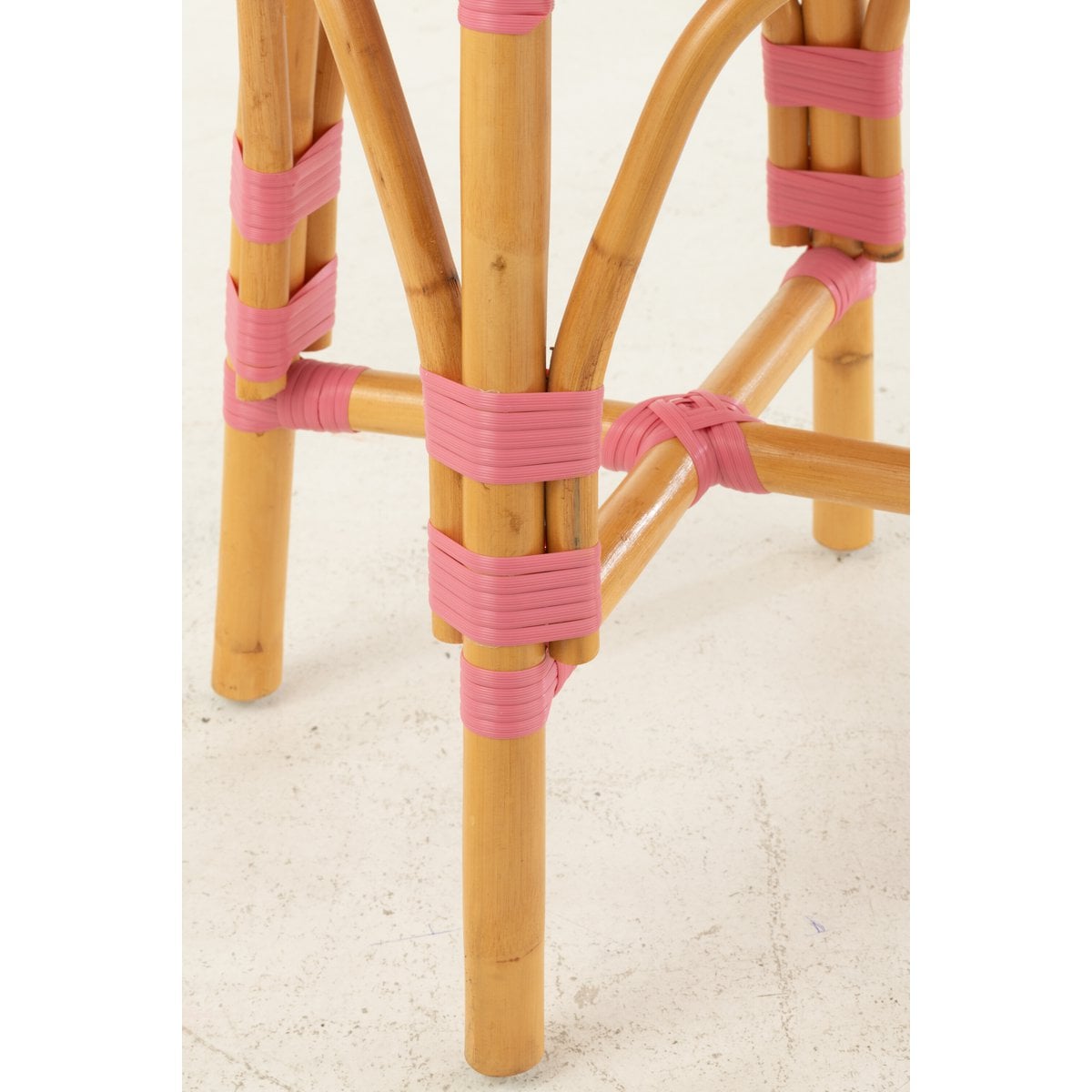Détail du tabouret en rotin rose, texture visible