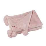 Plaid pompon rose J-Line sur un canapé élégant