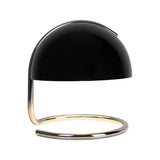 Lampe de table Burano noir allumée, créant une ambiance chaleureuse.