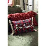 Coussin J-Line Check Bonheur sur un lit décoré