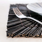 Set de table carré Varna en jonc de mer noir sur une table élégante.