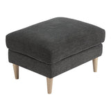 Pouf Bologna dans un salon moderne, utilisé comme repose-pieds