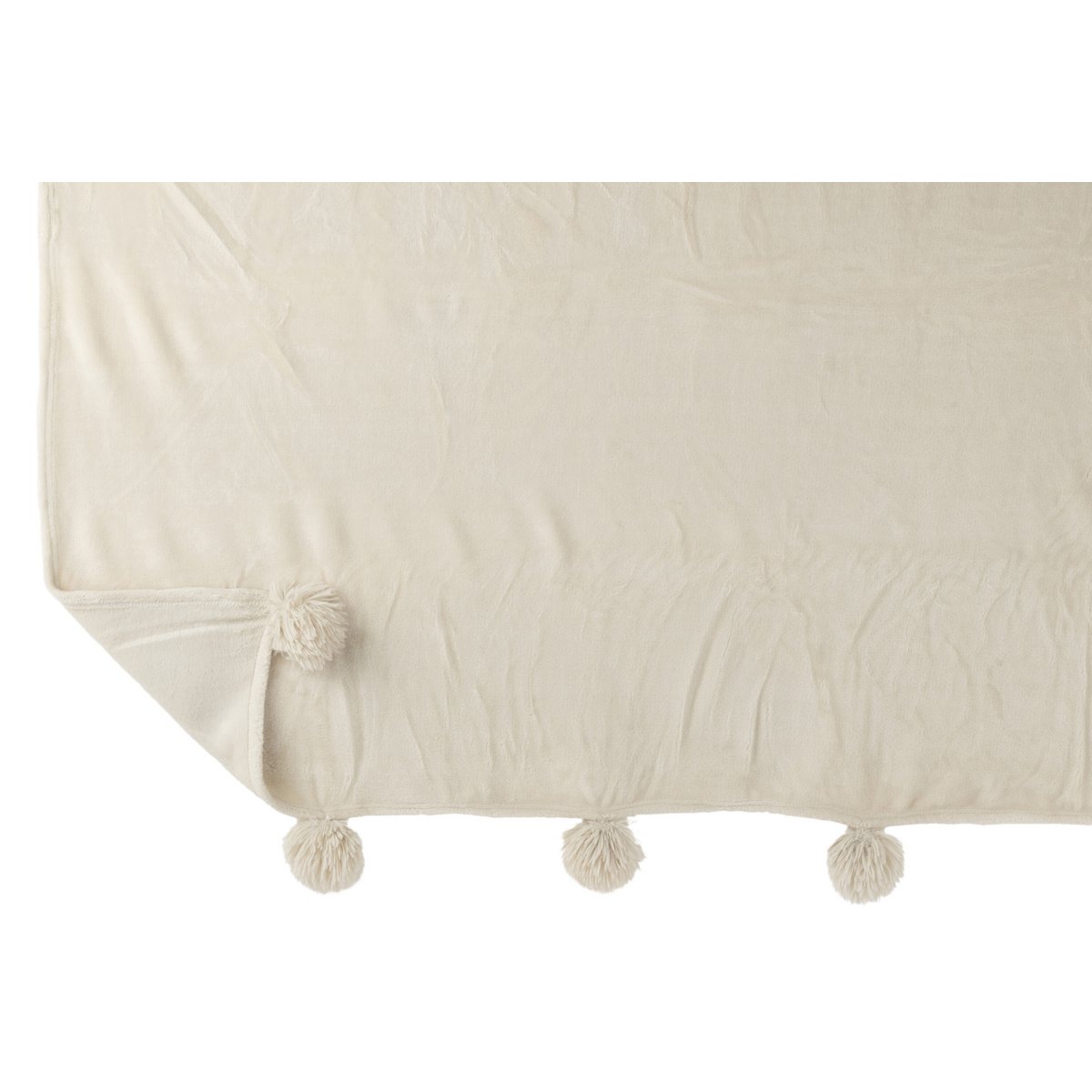 Plaid Pompon J-Line drapé sur un canapé moderne