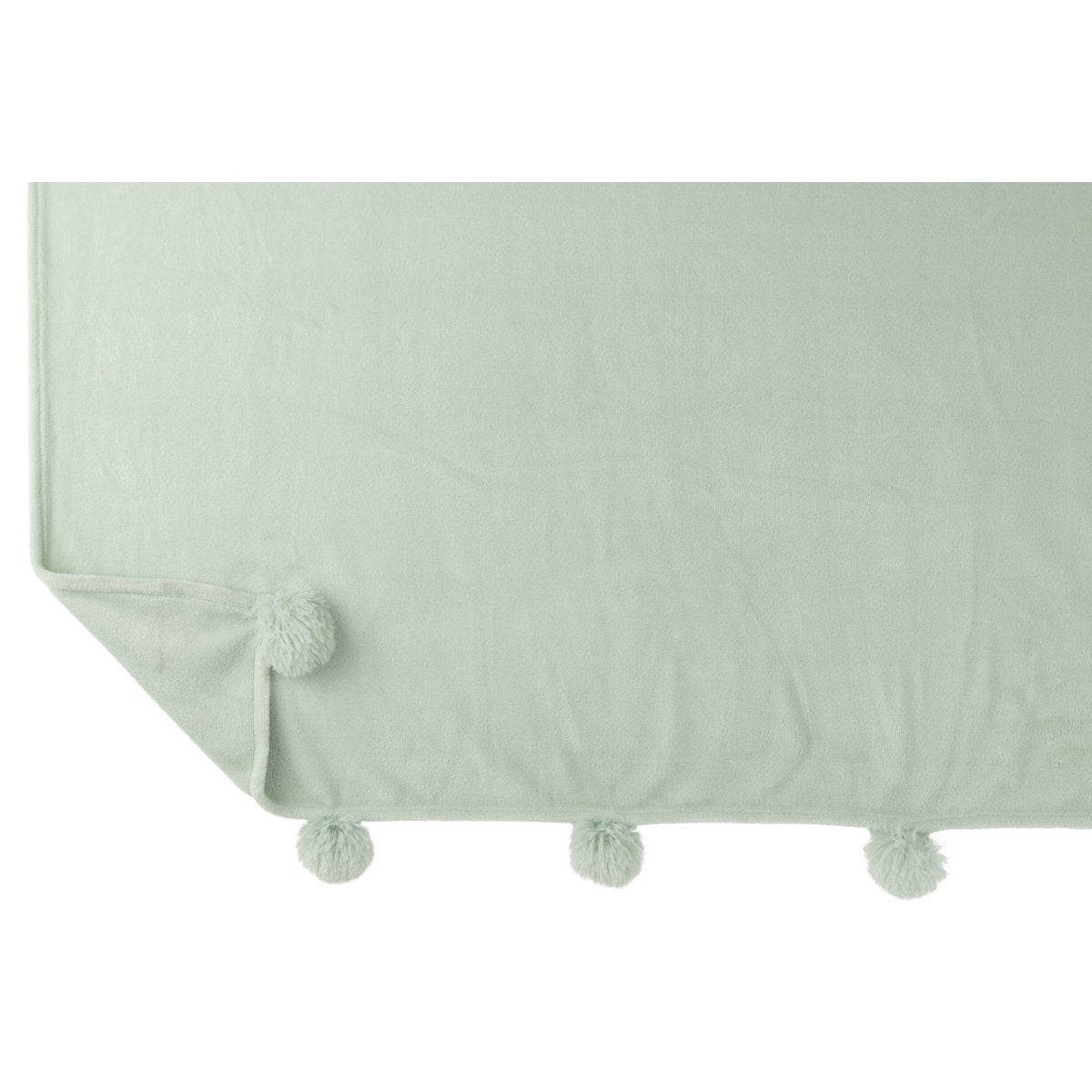 Plaid Pompon J-Line drapé sur un canapé élégant