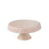 Détail de la texture de la planche à gâteau en céramique rose