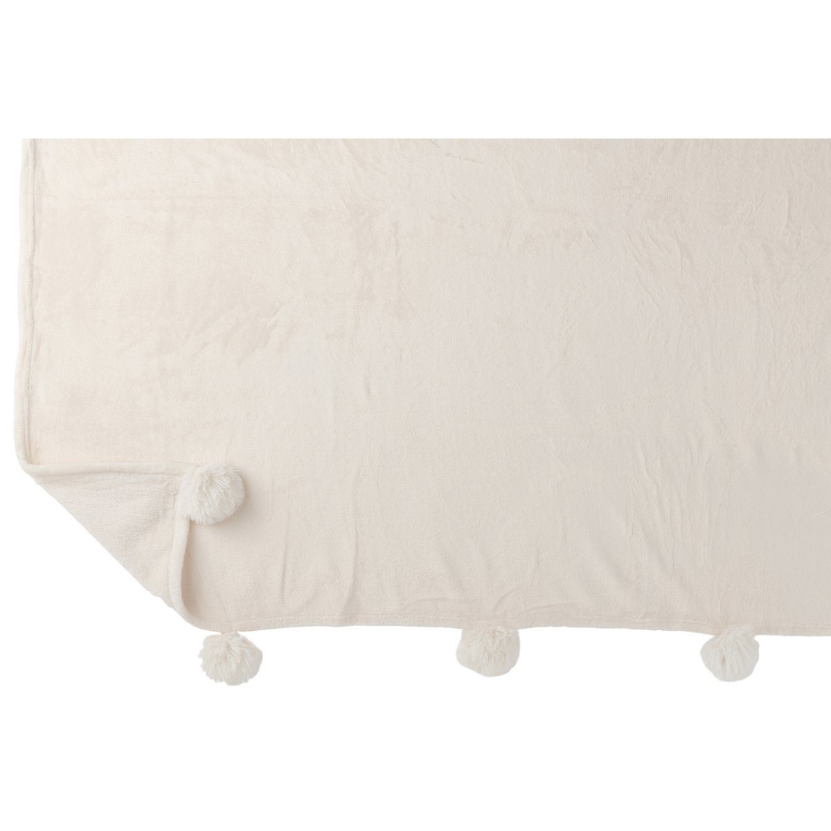 Plaid Pompon crème drapé sur un canapé