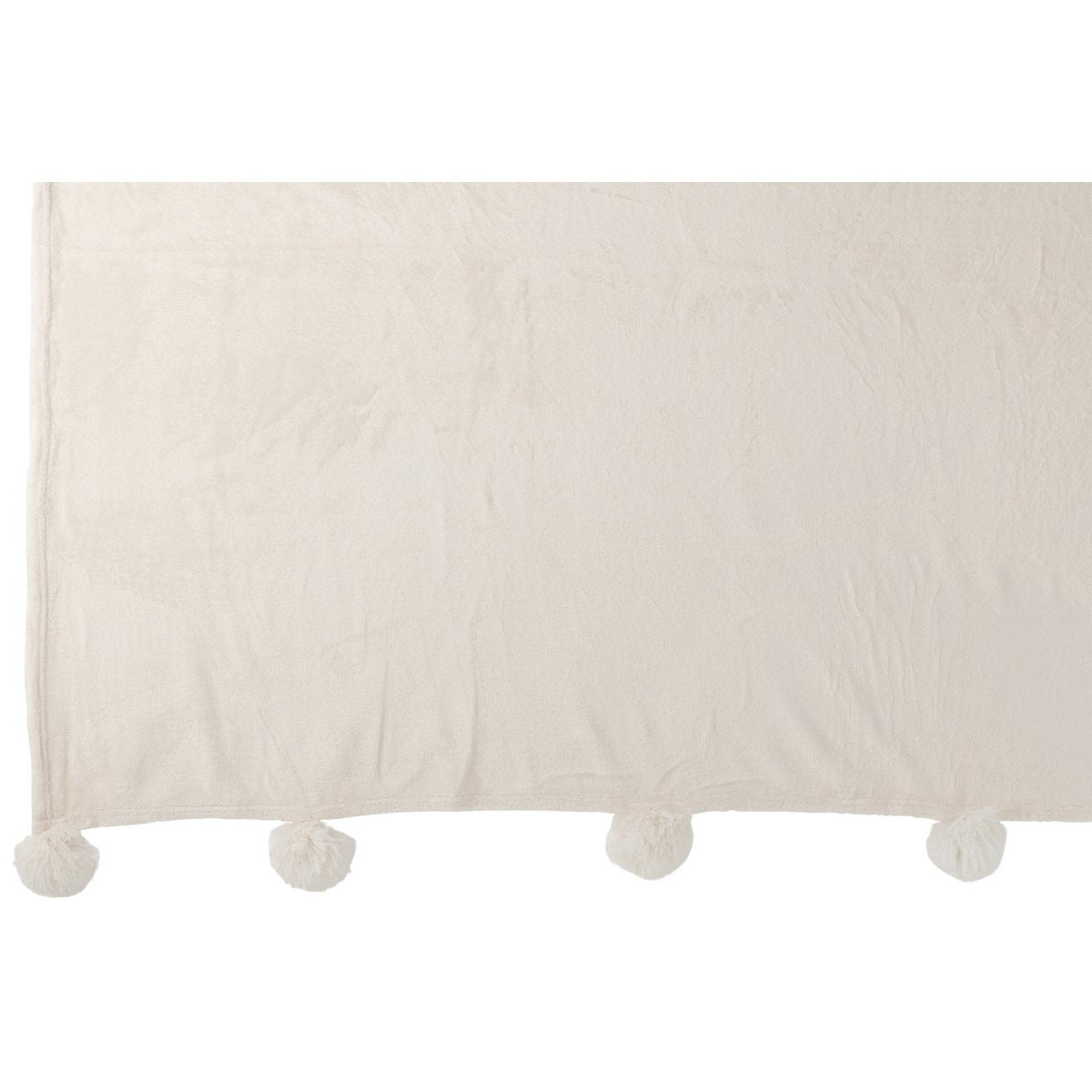 Plaid Pompon crème sur un lit élégant