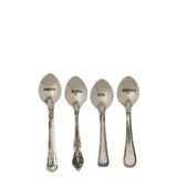 Lot de 4 cuillères J-Line en laiton et argent sur une table élégante