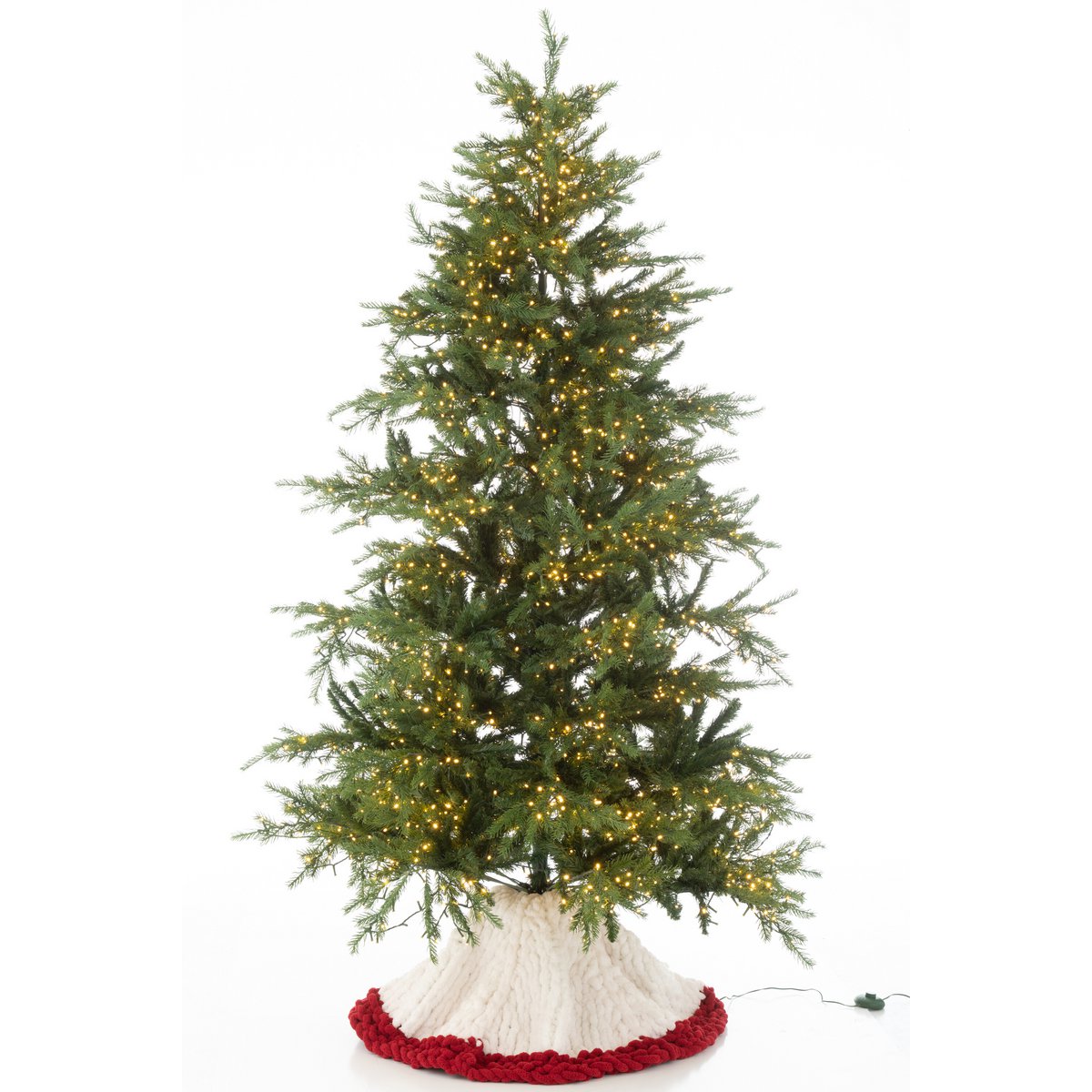 Jupe de sapin J-Line placée sous un sapin décoré
