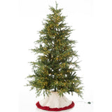Jupe de sapin J-Line placée sous un sapin décoré
