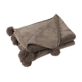 Ambiance cosy avec le plaid Pompom J-Line dans un salon