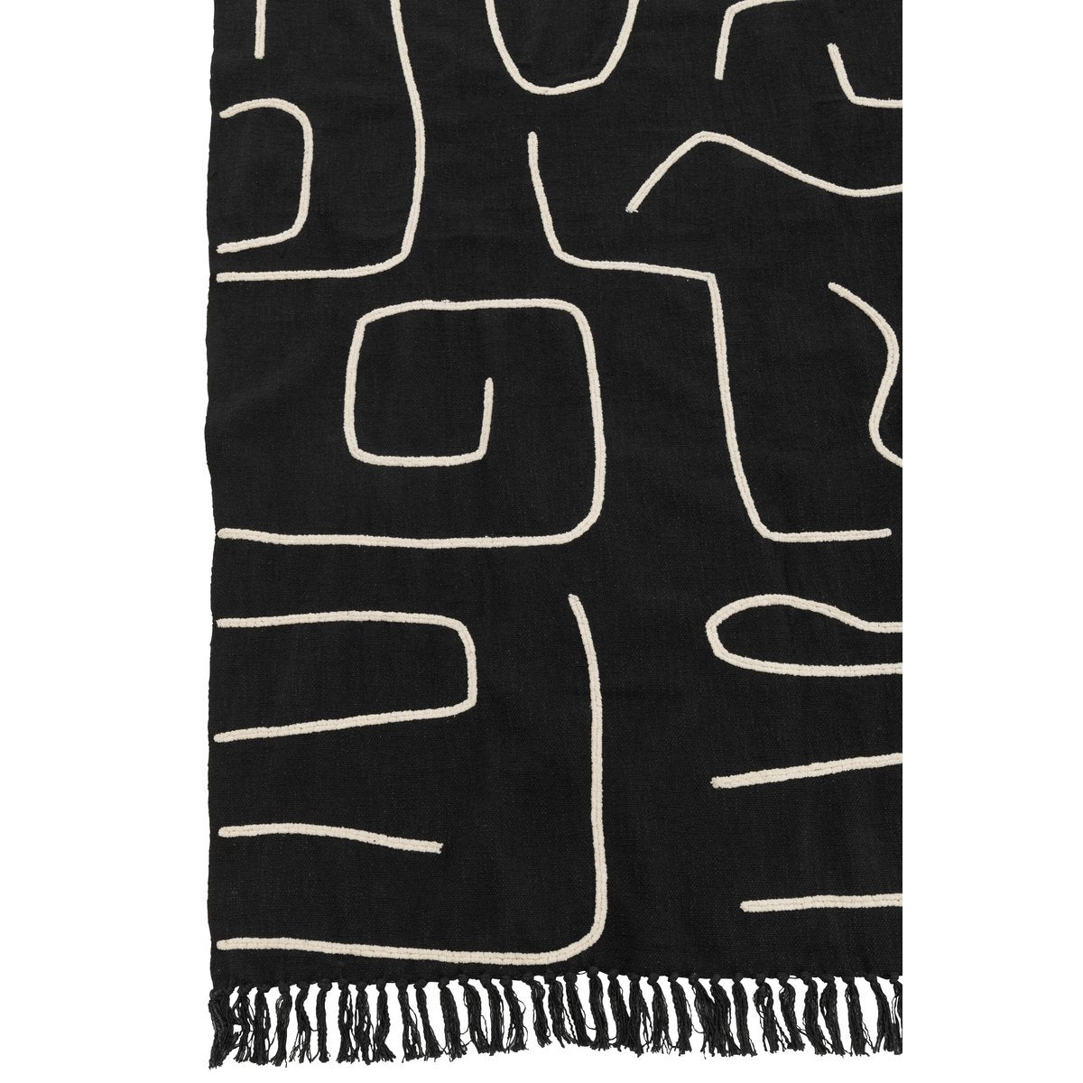 Plaid noir et blanc drapé sur un canapé élégant