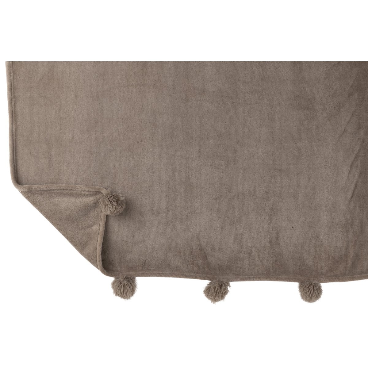 Plaid Pompon J-Line drapé sur un fauteuil élégant