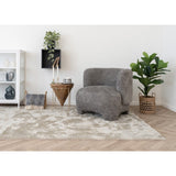 Plaid Izmir bleu plié sur un fauteuil élégant