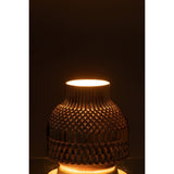 Vase J-Line Ari sur une table, ajoutant une touche de luxe