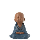 Moine Zen en résine bleu sur un fond élégant, ajoutant une touche artistique.