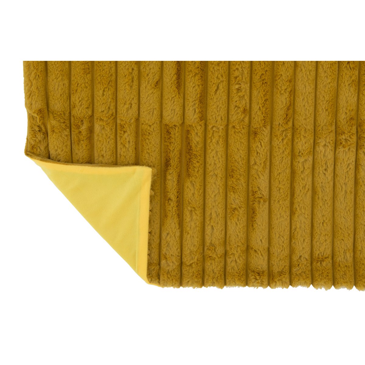 Plaid J-Line drapé sur un lit, ajoutant une touche de luxe