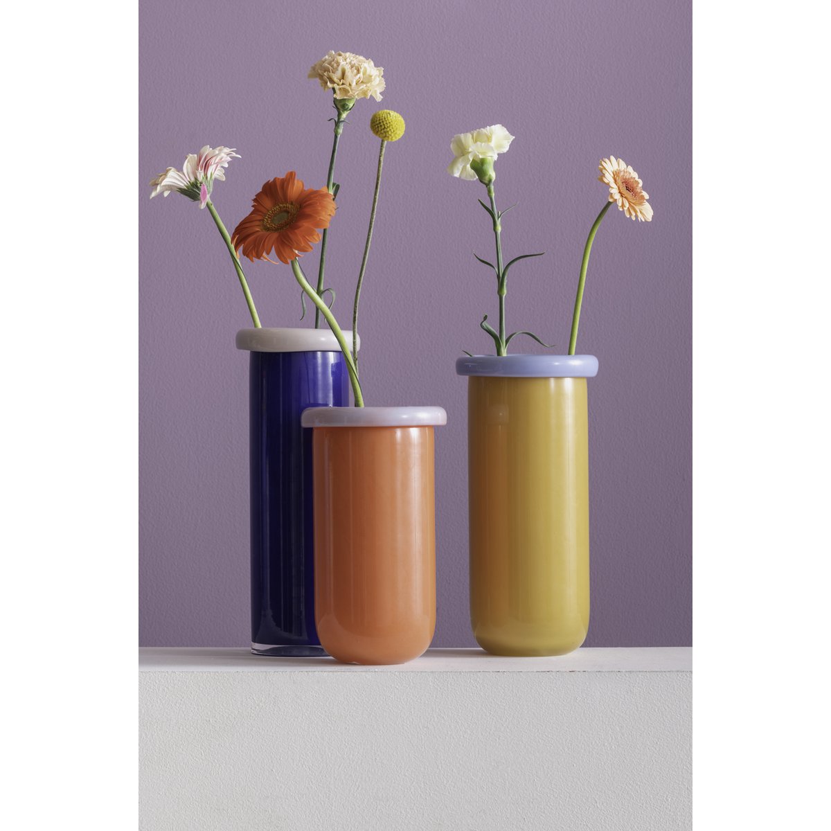 Vase Plié M en verre mauve, avec un bouquet de fleurs exubérantes