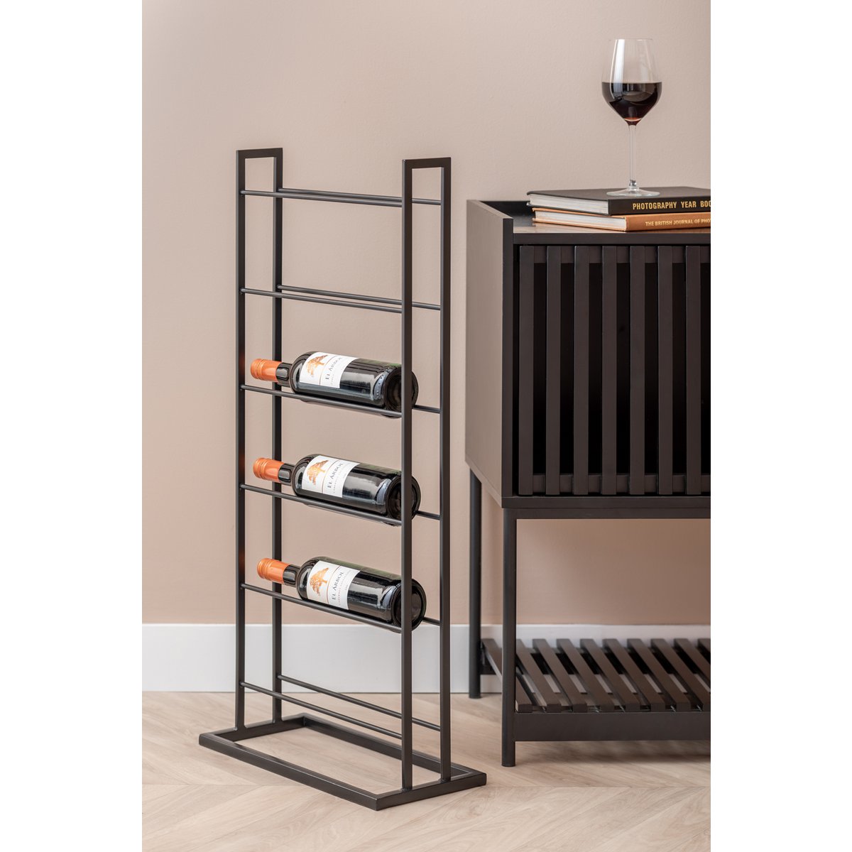 Casier à vin noir et or, intégré dans un salon moderne