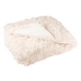 Ambiance cosy avec la couverture J-Line Moutie dans un salon