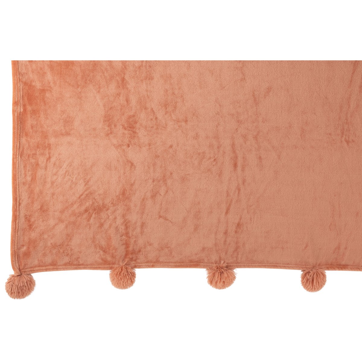 Plaid J-Line pêche drapé sur un canapé