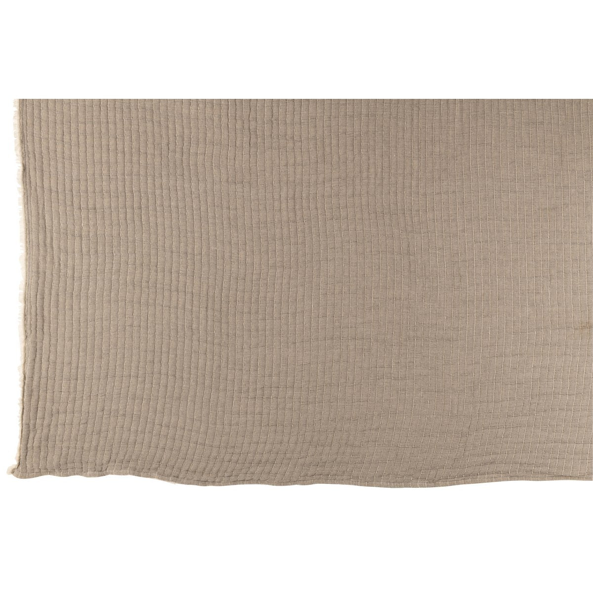 Plaid J-Line gris drapé sur un canapé scandinave