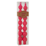 Bougies J-Line fuchsia en gros plan, texture cire