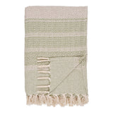 Plaid Manisa vert et beige sur canapé, texture douce et élégante