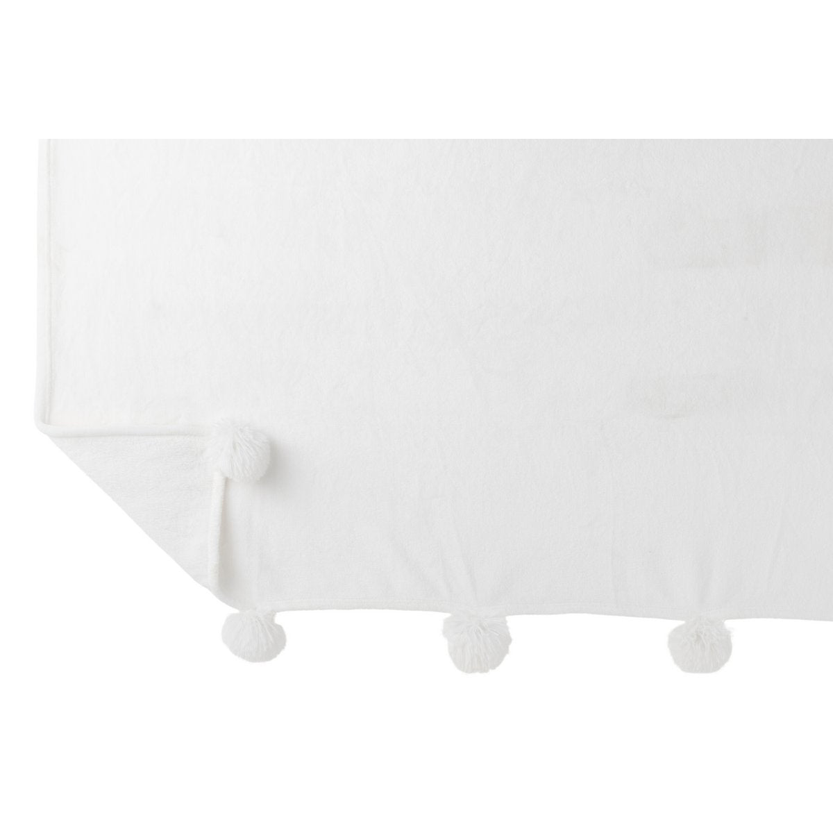 Plaid Pompon J-Line drapé sur un canapé, montrant sa texture douce
