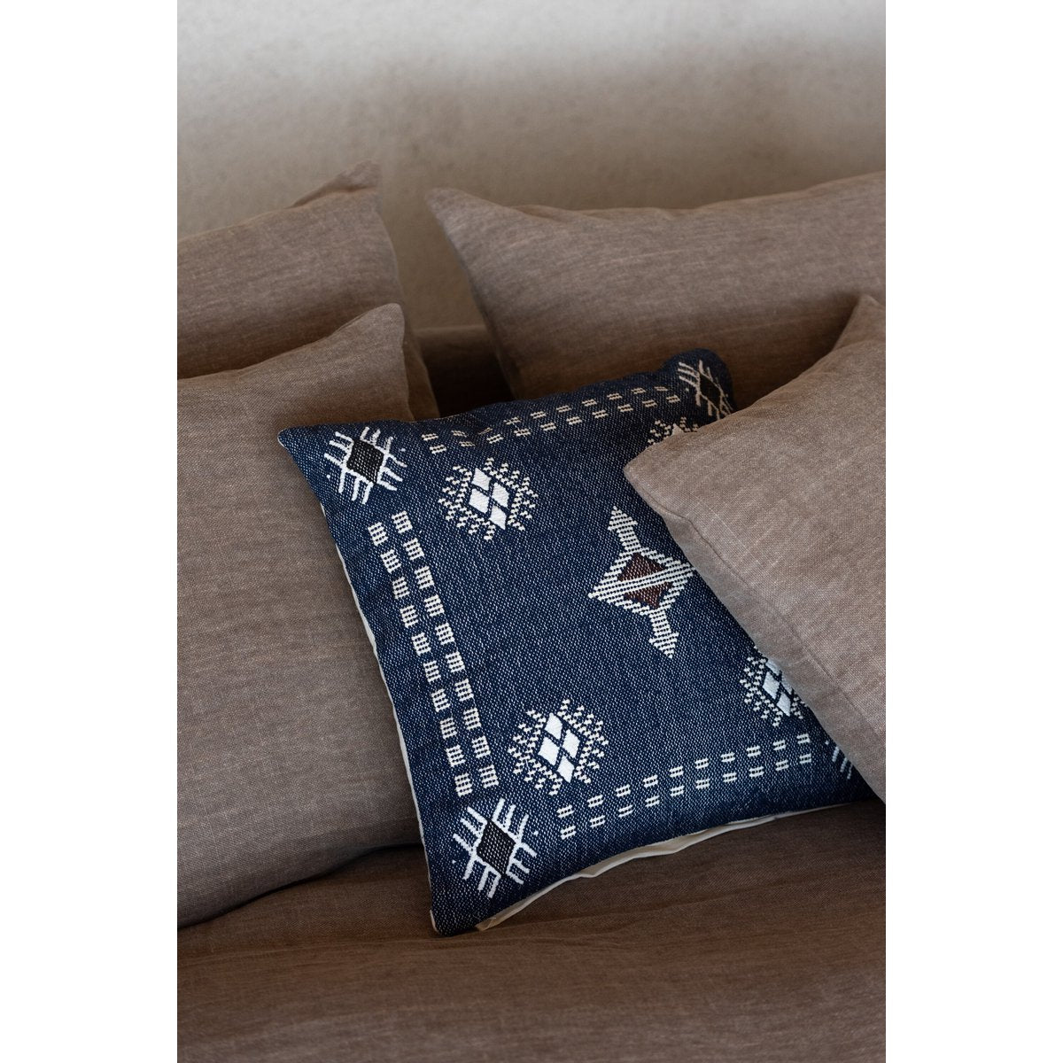 Coussin carré J-Line sur un canapé, ajoutant une touche de décoration bohème.